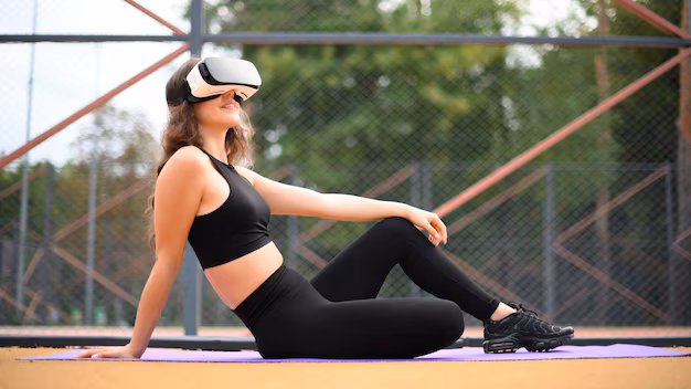 Mujer que llevaba un VR auricular mientras está sentado en una estera de yoga | ONS cesta | PGN Business Insider