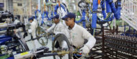 Indian workers in a manufacturing facility | Trump's tariff war | PGN Business Insider