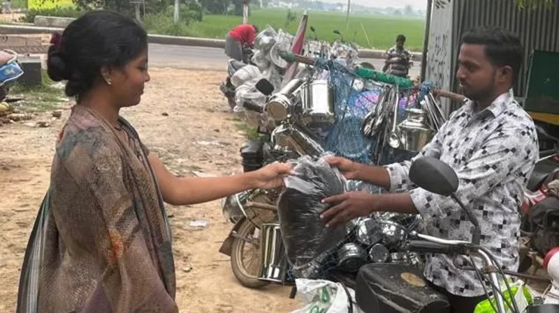 Kolachi Venkatesh, a seasoned hair trader, receiving a bag of collected hair from a local woman. | Wig Industry in India