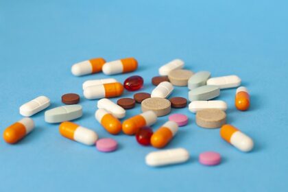 pills are scattered on a blue background | US-India tariffs | PGN Business Insider