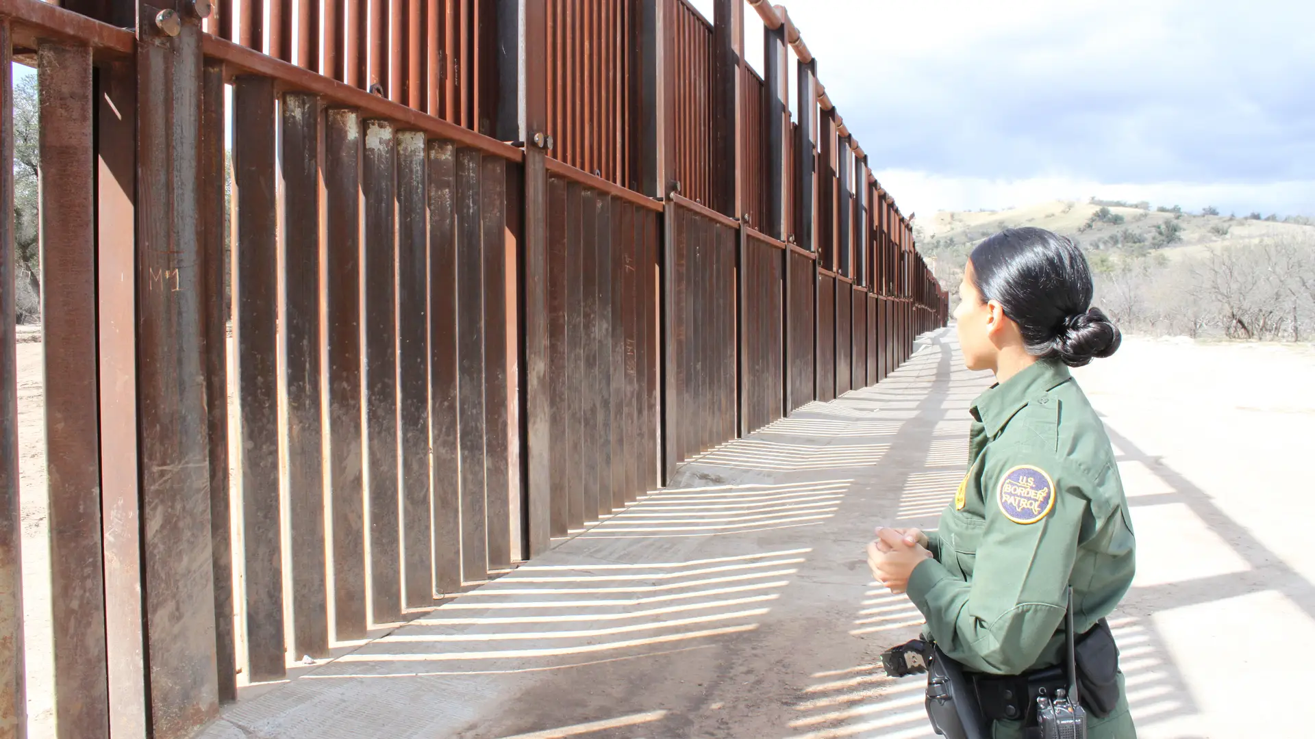 Trump Tariffs: A border checkpoint between the U.S. and Mexico, emphasizing immigration control.