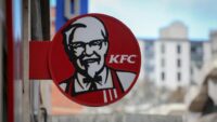 KFC restaurant storefront featuring Colonel Sanders’ logo and fried chicken signage.