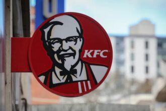 KFC restaurant storefront featuring Colonel Sanders’ logo and fried chicken signage.