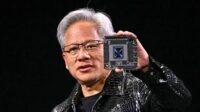 Nvidia CEO Jensen Huang holding an AI chip at CES, symbolizing the company’s dominance in AI hardware | Nvidia AI chips