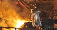 Steelworker in a UK steel plant wearing protective gear