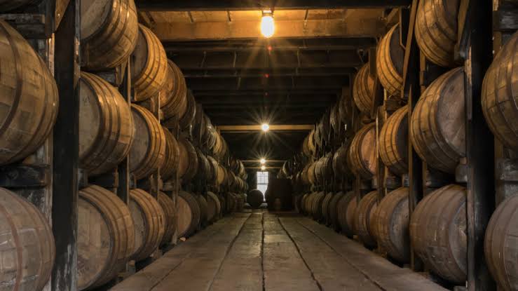 Aged whisky barrels in a Scottish distillery warehouse | English single malt whisky