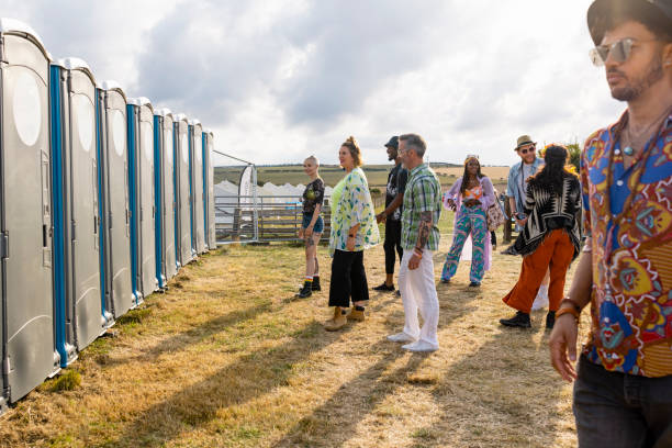 Crowded restroom queue at a NZ tourist site.