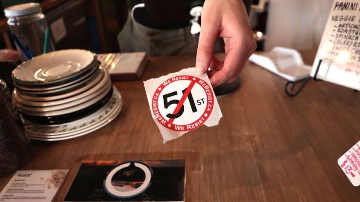 A coffee shop in Toronto hands out anti-51st state stickers to customers. Canadian boycott