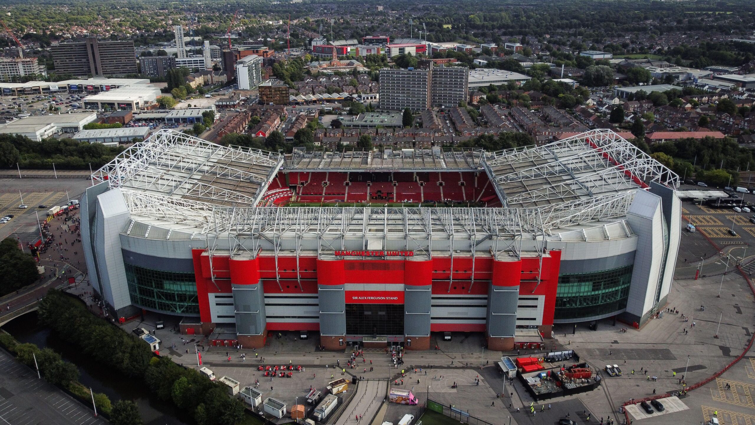 Fans and local residents discussing Manchester United's new stadium plans at a community meeting. Man Utd stadium