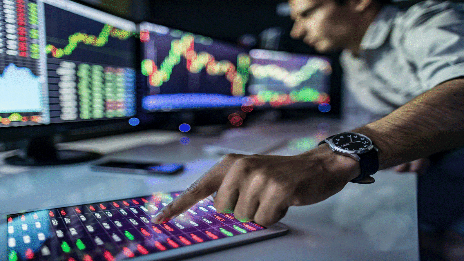 Indian investors monitor stock market trends on digital devices | India stock market