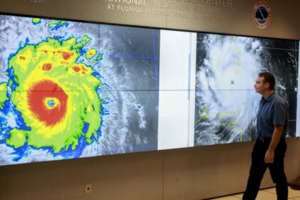 NOAA staff inspecting a satellite image of Hurricane Beryl, symbolizing the agency’s role in storm tracking