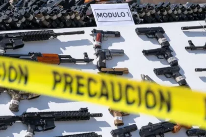 Recovered guns behind a yellow police tape | Mexico gun lawsuit