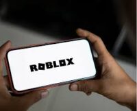 Roblox logo displayed on a smartphone screen. Roblox safety concerns