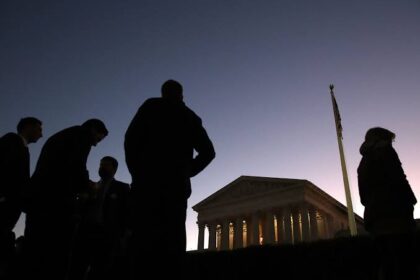 Shadow of a man standing in front of a government building, symbolizing the legal challenge to federal workers firings.