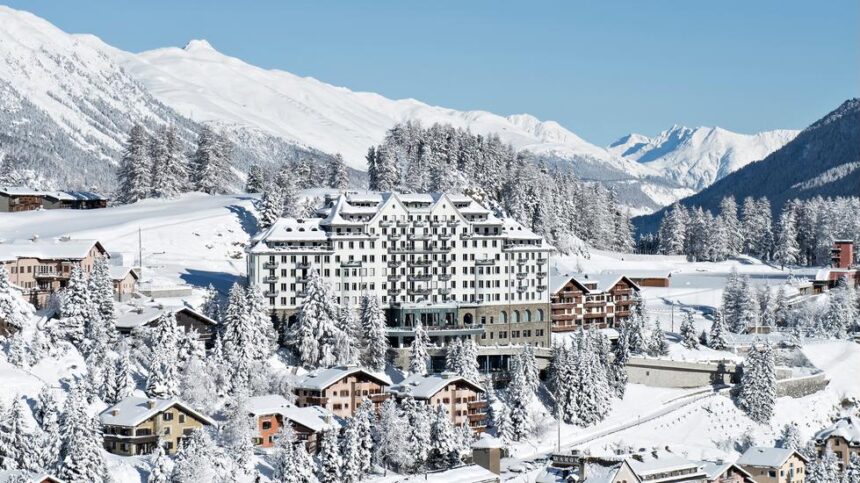 Swiss Alps luxury hotel with ski slopes in background | Switzerland luxury tourism