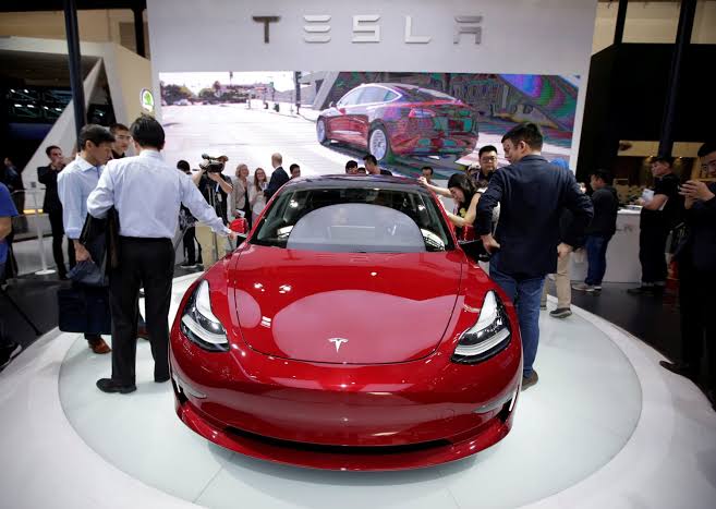 Tesla Model 3 displayed at a Berlin auto show, Tesla EVs